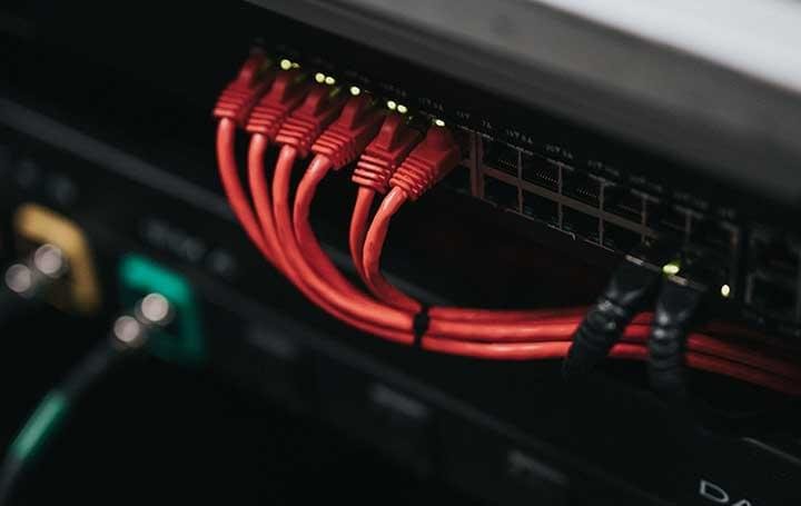 Network cables plugged into a switch in a data centre